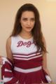 A woman in a cheerleading uniform posing for a picture.