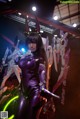 A woman in a purple outfit holding a sword.